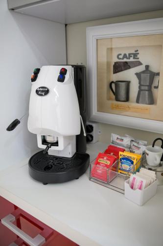 a white coffee maker sitting on top of a counter at Venere apartement house in Montalto Uffugo