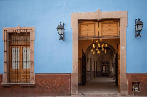 a blue building with two doors and two lights at Casa Montespejo B&B in Querétaro