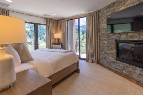 a bedroom with a large bed and a fireplace at The Snowpine Lodge in Alta