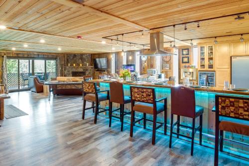 an open kitchen with a bar with stools at Hot Tub and Mtn Views Epic Stateline Escape! in Stateline