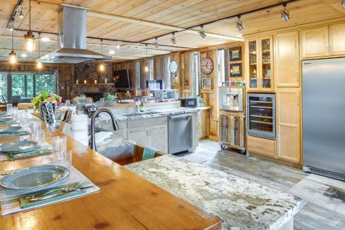 a large kitchen with wooden cabinets and stainless steel appliances at Hot Tub and Mtn Views Epic Stateline Escape! in Stateline