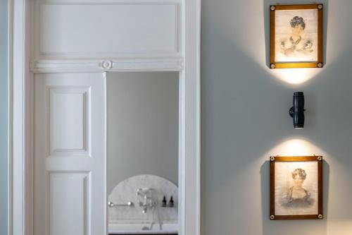 a white door with a mirror in a bathroom at Valverde Santar Hotel & SPA - Relais & Châteaux in Santar