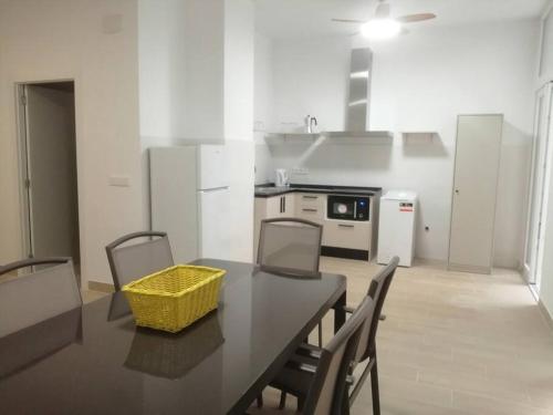 a kitchen with a table with a yellow basket on it at TwinFlats 2 in Valencia
