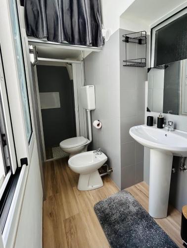 a small bathroom with a toilet and a sink at Essential House in Brindisi