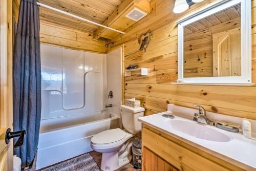 a bathroom with a toilet and a sink and a tub at Mammoth Cave Cabin Rentals 4 in Cub Run