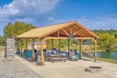 a wooden pavilion with a picnic table and chairs at Mammoth Cave Cabin Rentals 8 in Cub Run