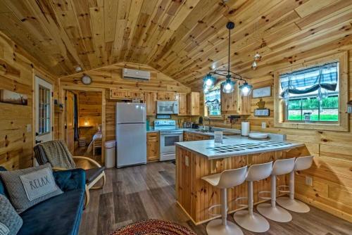 a kitchen and living room in a log cabin at Mammoth Cave Cabin Rentals 8 in Cub Run