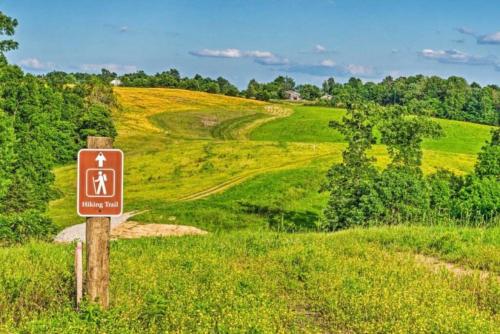 a sign on the side of a grassy field at Mammoth Cave Cabin Rentals 7 in Cub Run