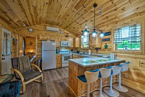 a kitchen with wooden walls and a wooden ceiling at Mammoth Cave Cabin Rentals 7 in Cub Run