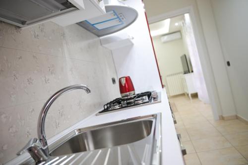 a kitchen with a sink and a stove at Venere apartement house in Montalto Uffugo