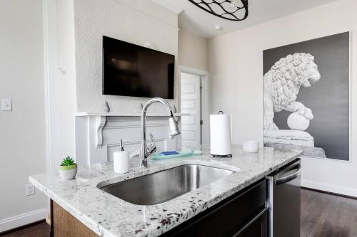 a kitchen counter with a sink and a tv at Modern, Convenient Gem: Urban Retreat 'n Richmond in Richmond
