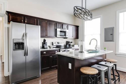 a kitchen with a stainless steel refrigerator and a counter at Modern, Convenient Gem: Urban Retreat 'n Richmond in Richmond