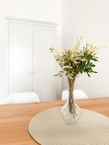 a vase of flowers sitting on a table at Jen tak spolu - apartmán Znojmo in Znojmo