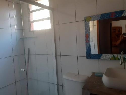 a bathroom with a sink and a mirror and a toilet at Chacara Vale dos Sonhos Itu in Itu