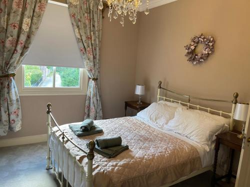 a bedroom with a bed and a window at Cherry Tree in York