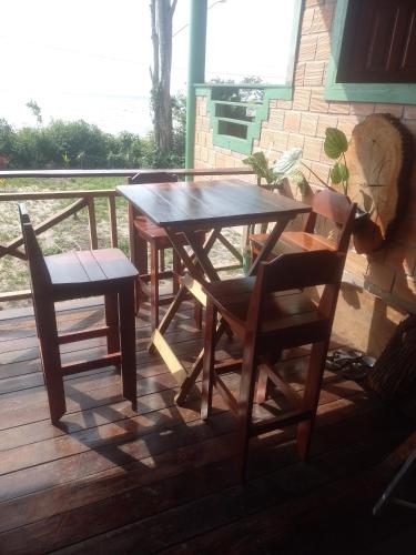 a wooden table and chairs on a deck at recanto rios Belém in Mosqueiro