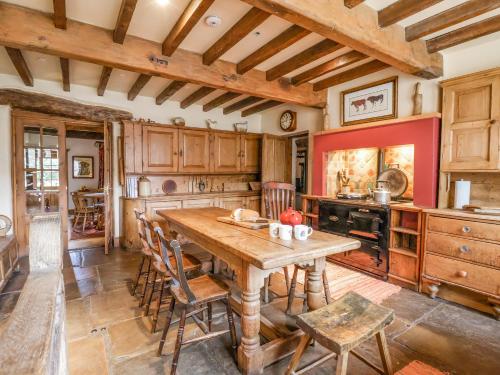 a kitchen with a wooden table and chairs at Bay Horse Farm in Skipton