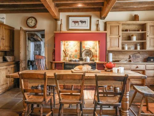 a kitchen with a wooden table and chairs at Bay Horse Farm in Skipton