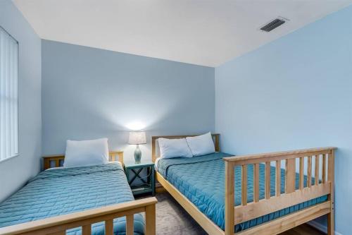 a bedroom with two beds and a window at Across the Street from Beach Access-Pool & Garage-Sleeps 6-Sea Castle 12 in Fernandina Beach