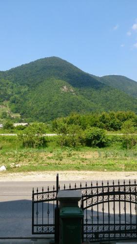 a fence on the side of a road with a mountain at Apartments Kamenecki in Krapina