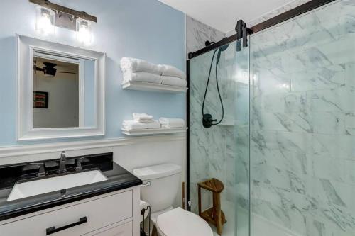 a bathroom with a shower and a toilet and a sink at Across the Street from Beach Access-Pool & Garage-Sleeps 6-Sea Castle 12 in Fernandina Beach