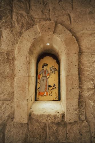 a painting of a woman with a horse on a wall at Hu of Cappadocia - Special Class in Uchisar