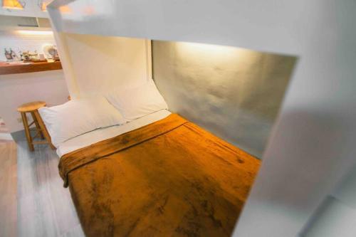 a small room with a bed with at Kozy Haven - Wifi + AC in Butuan