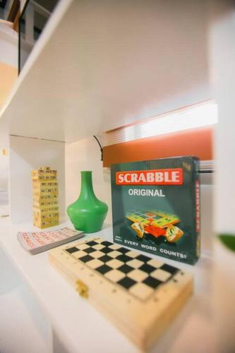 a table with a chessboard and a book and a vase at Kozy Haven - Wifi + AC in Butuan