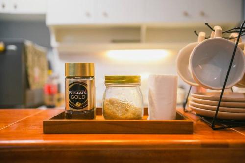 a counter with two jars of spices on a table at Kozy Haven - Wifi + AC in Butuan