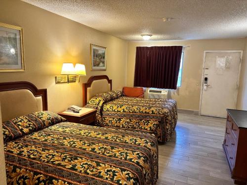 A bed or beds in a room at Highland Inn