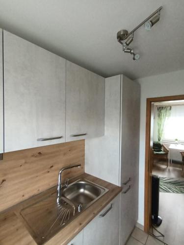 a kitchen with a sink and a counter top at Apartment Schwalbenweg - Günstige Langzeitvermietung in Gelnhausen