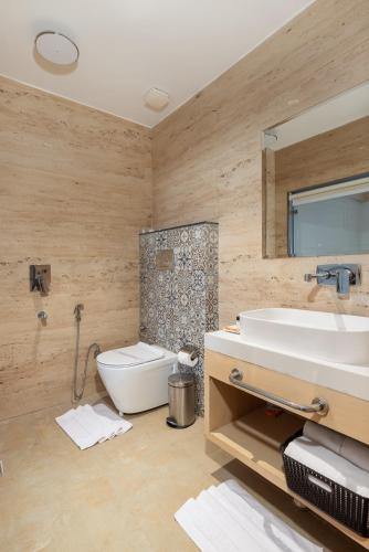 a bathroom with a sink and a toilet at Hotel Caesars Palace in Bhopal