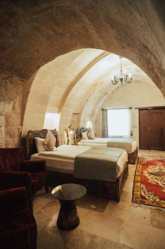 a large room with two beds and a couch at Hu of Cappadocia - Special Class in Uchisar