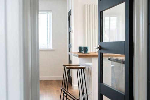 a kitchen with a bar and a stool in a room at Bungalow in Keynsham in Keynsham