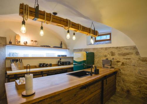 a kitchen with a wooden counter top in a room at Selské stavení Melchior Häusler in Šonov