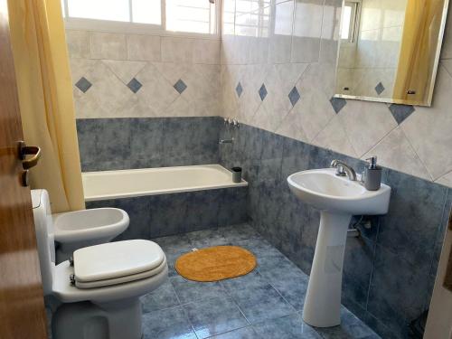 a bathroom with a sink and a toilet and a tub at KAD Alojamiento in Mendoza