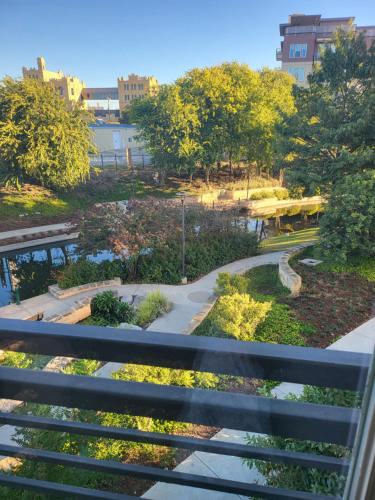 a view of a park from a balcony at Beautiful Condo on Riverwalk w King Ste Free Parking Pet friendly centrally Located on the Riverwalk in San Antonio