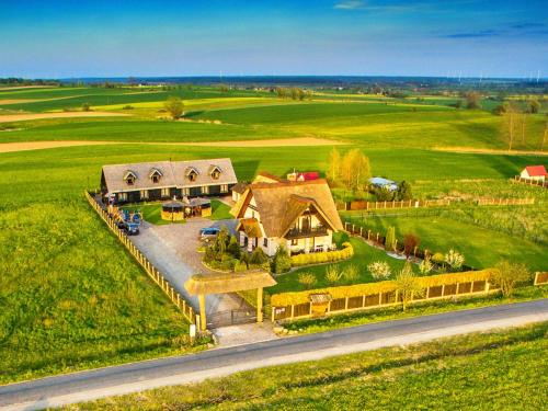 an aerial view of a house in the middle of a field at Seaside Cottage in Cisowo with terrace and lovely garden in Darłowo