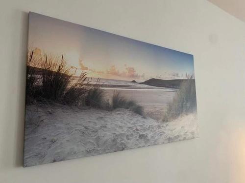 een schilderij van een strand met zand en gras bij Take a break apartment in Ustka
