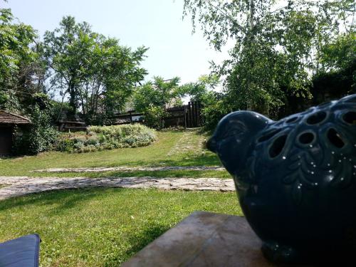 a black bird statue sitting on top of a table at Köveskál Panzió in Köveskál