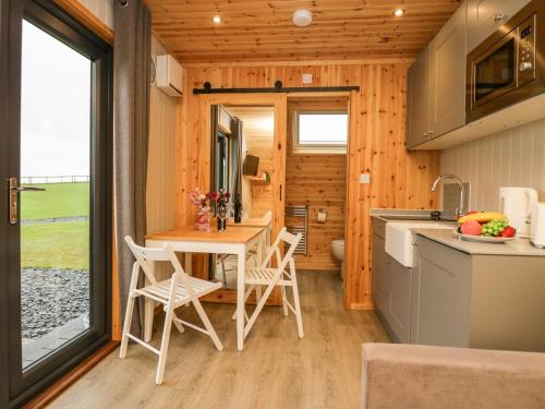 a kitchen and dining room of a tiny house at Orchard in Dalton in Furness