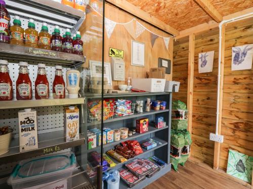 a store filled with lots of drinks and food at Orchard in Dalton in Furness