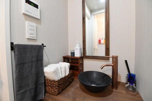 a bathroom with a black sink and a mirror at Hotel Tokyo Hub - Vacation STAY 27688v in Tokyo