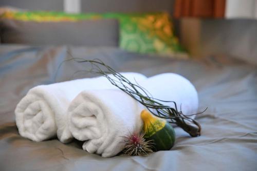 a towel on a bed with a fruit and a pineapple at Hotel Tokyo Hub - Vacation STAY 27684v in Tokyo