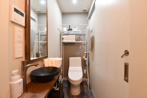 a small bathroom with a toilet and a sink at Hotel Tokyo Hub - Vacation STAY 27692v in Tokyo