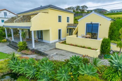 an aerial view of a yellow house at Casa dos Lagos - RRAL nº 2187 in Velas