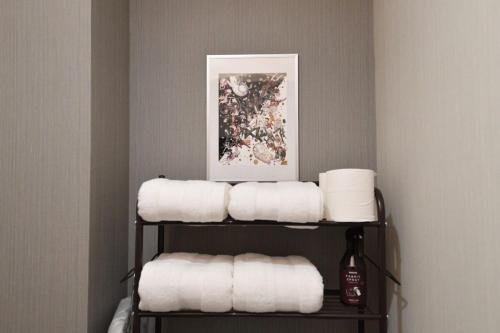 a bunch of towels on a shelf in a bathroom at Hotel Tokyo Hub - Vacation STAY 27674v in Tokyo