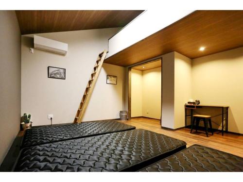 a room with a ladder and a black mattress at Guest House Garage IMAZU - Vacation STAY 15208 in Takashima