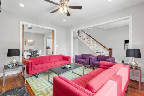 a living room with red couches and purple chairs at Spacious, Vibrant Home 'n Central Richmond, VA! in Richmond