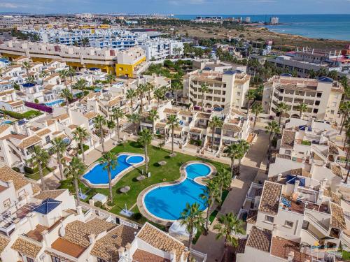 an aerial view of a resort with a pool and buildings at CASA DE FLAMENCO in Orihuela Costa